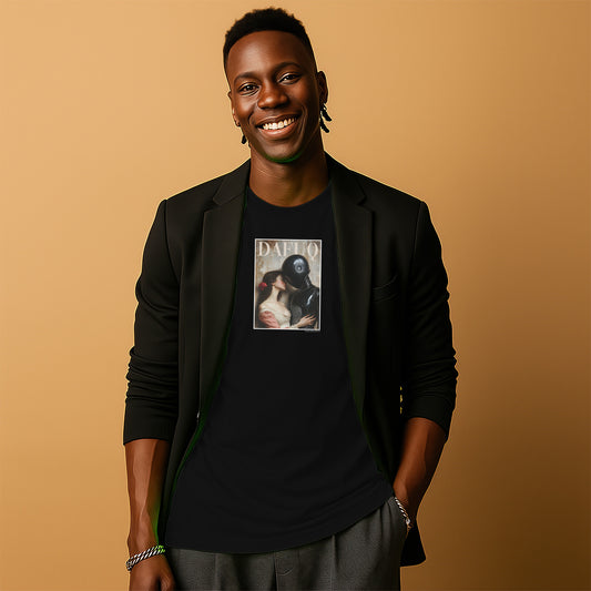 A smiling man wearing a black blazer and a black t-shirt with a graphic design stands against a peach-colored background.