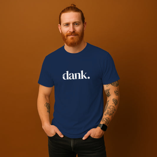 A man with a beard wearing a blue t-shirt with the word "dank" printed on it, standing against a brown background.