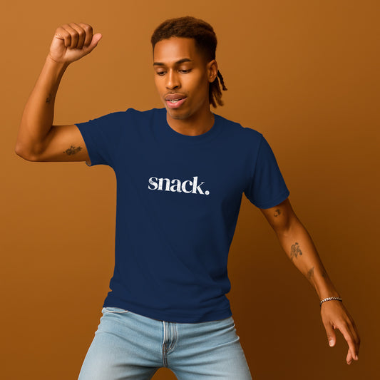 A man wearing a blue t-shirt with the word "snack" printed on it, smiling and raising his fist in the air.