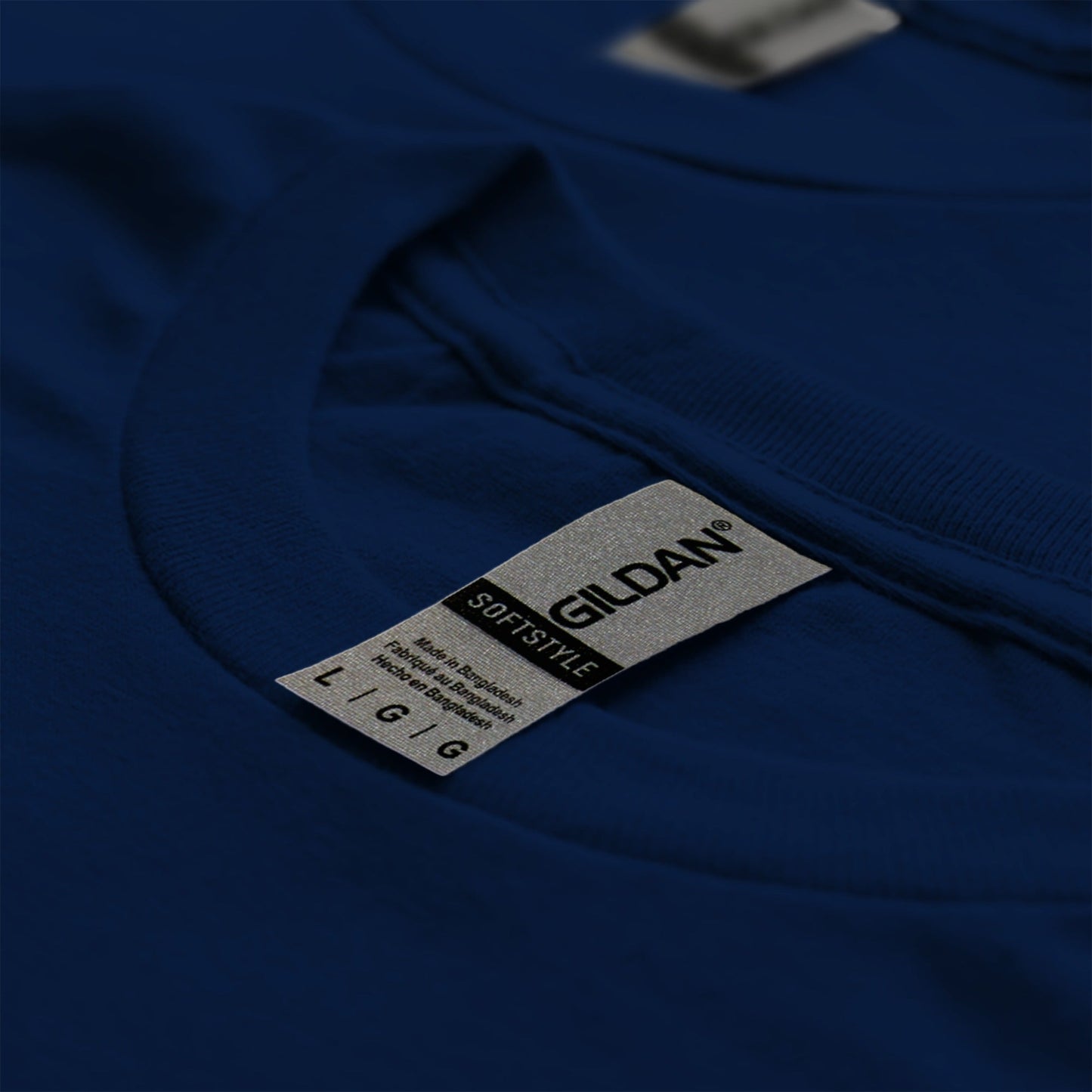 A close-up view of a dark blue t-shirt with a label attached to it.