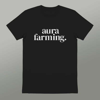 A black t-shirt with white text that reads "aura farming".