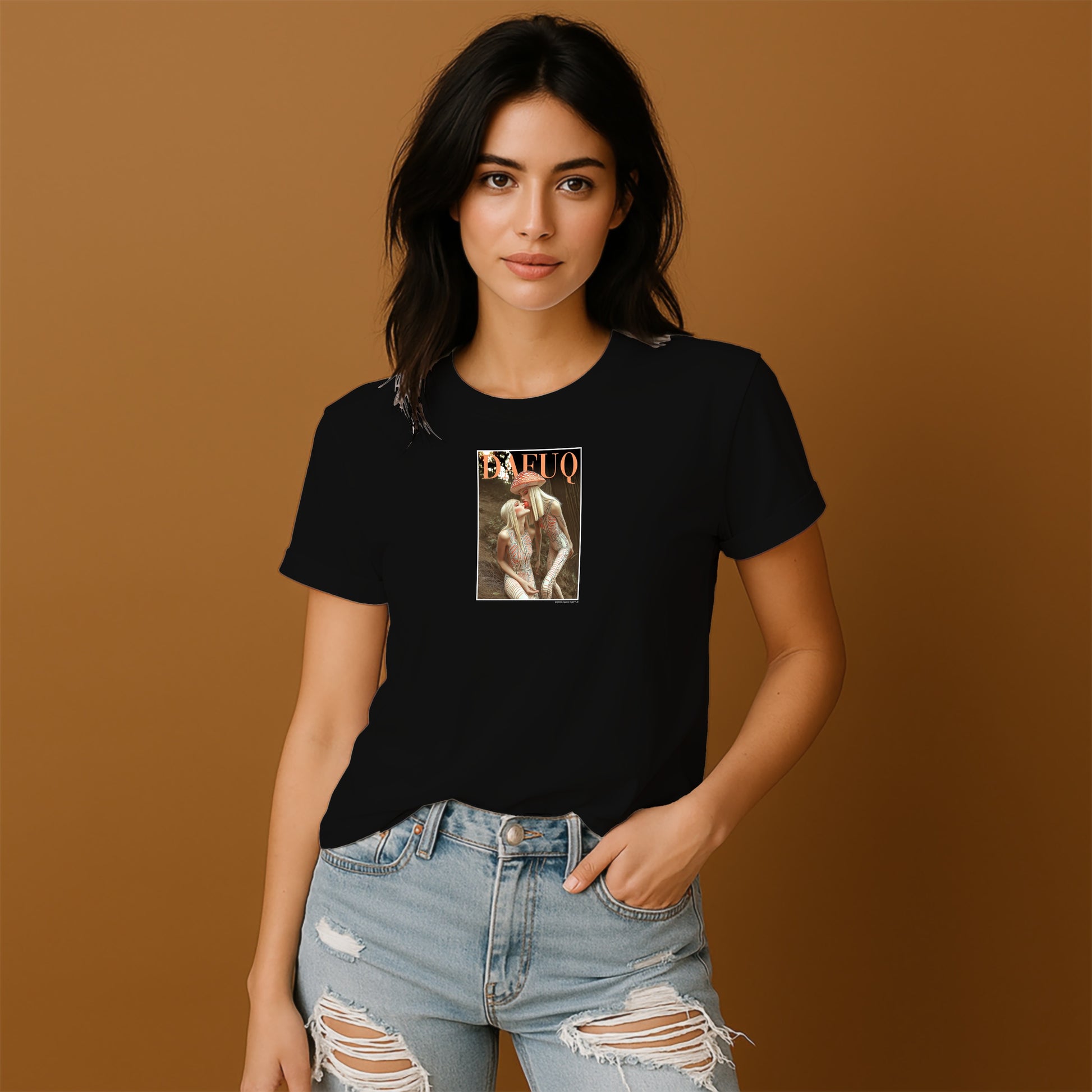 A young woman wearing a black t-shirt with a graphic design and ripped jeans stands against a brown background.