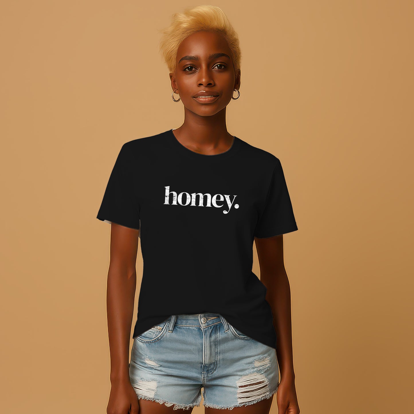 A woman with blonde hair wearing a black t-shirt with the word "honey" printed on it, paired with distressed denim shorts.