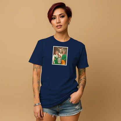 A young woman with short red hair wearing a navy blue t-shirt with a framed photo of three people on it, standing against a beige background.