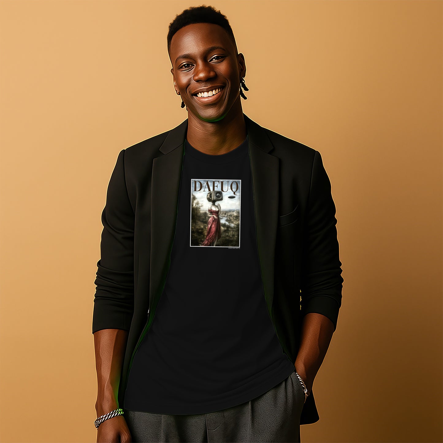 A smiling man wearing a black blazer and a black t-shirt with a graphic design stands against a beige background.