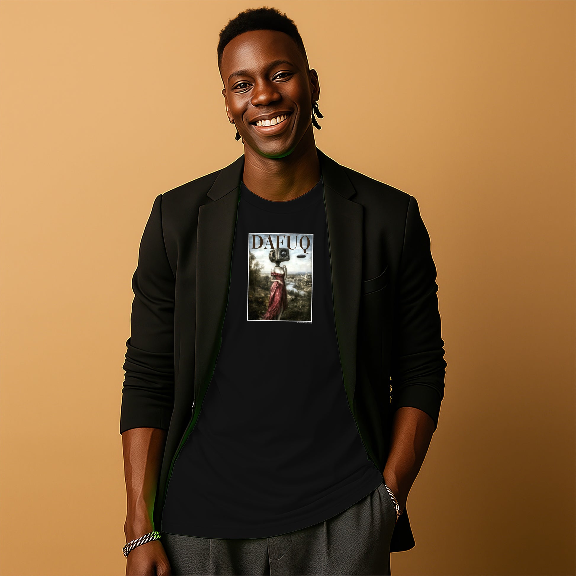 A smiling man wearing a black blazer and a black t-shirt with a graphic design stands against a beige background.