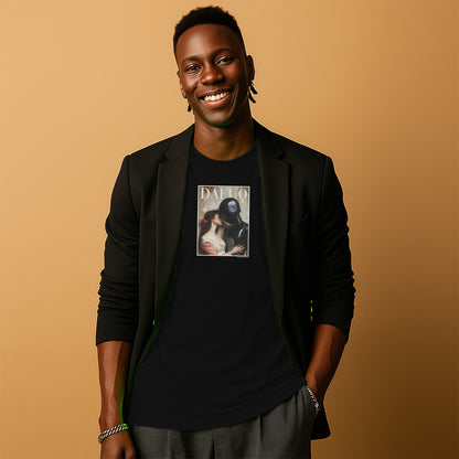 A smiling man wearing a black blazer and a black t-shirt with a graphic design stands against a peach-colored background.