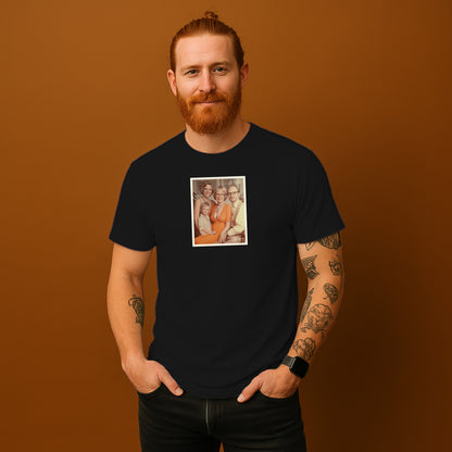 A man with a beard wearing a black t-shirt with a framed photograph of three people on it.