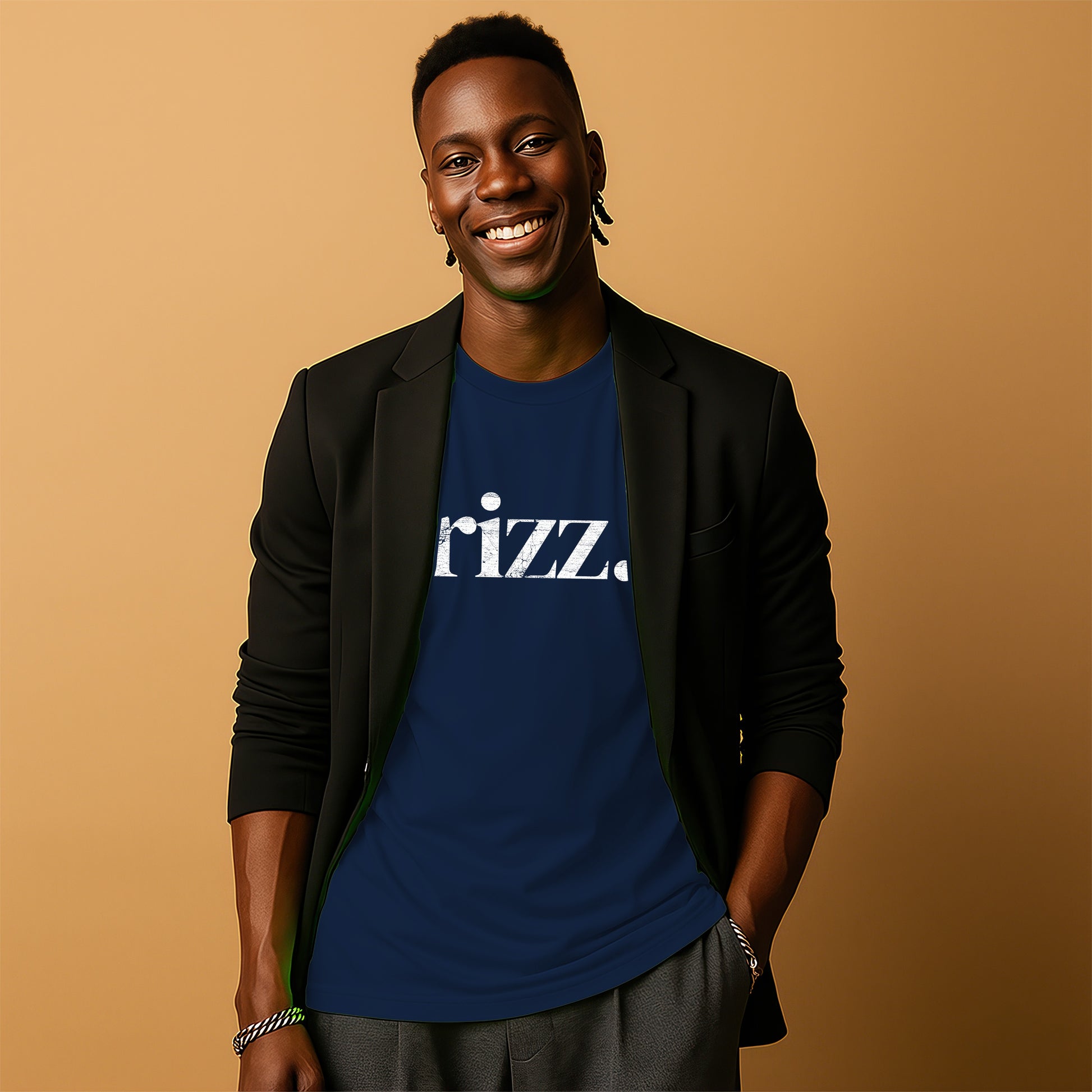 A smiling man wearing a black blazer and a blue t-shirt with the word "razz" printed on it.